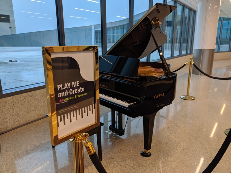 A baby grand piano at LAX international airport